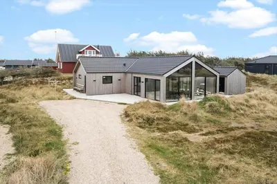 a house on a beach with a gravel road at 336-Harboore-Hvilehjemsvej-23 in Harboør