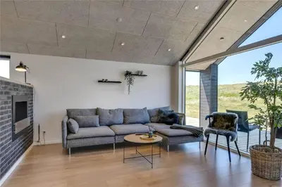 a living room with a couch and a fireplace at 340-Harboore-Byskovvej-40 in Harboør