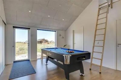 a room with a pool table and a ladder at 340-Harboore-Byskovvej-40 in Harboør