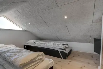 a bedroom with two beds and a ceiling at 340-Harboore-Byskovvej-40 in Harboør