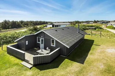 an overhead view of a black house with a deck at 168-Harboore-Emblavej-1 in Harboør