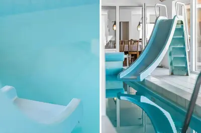 a slide in a house with blue walls and stairs at 159-Harboore-Alkajavej-6 in Harboør