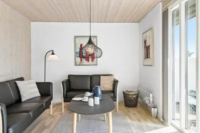 a living room with a couch and a table at 115-Harboore-Strandvejen-164 in Harboør