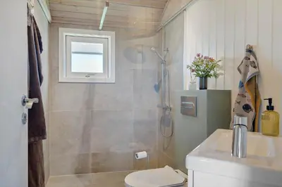 a bathroom with a shower and a toilet and a sink at 286-Harboore-Neerlandiavej-198 in Harboør