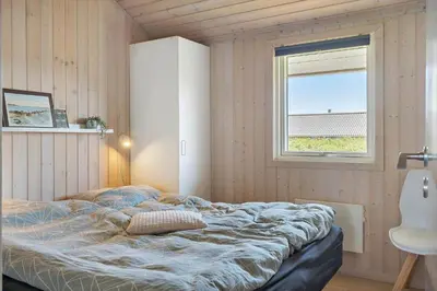 a bedroom with a bed and a window at 286-Harboore-Neerlandiavej-198 in Harboør