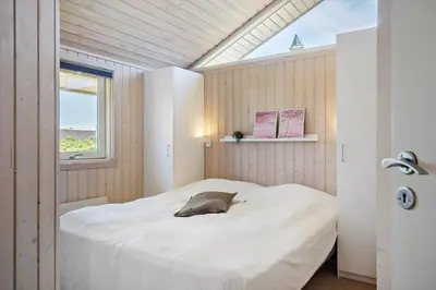 a bedroom with a bed in a room with a window at 286-Harboore-Neerlandiavej-198 in Harboør
