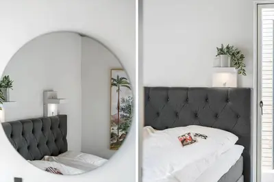 a bedroom with a bed and a mirror at 265-Harboore-Lucievej-6-b in Harboør