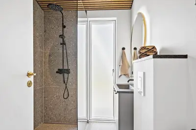 a bathroom with a shower with a glass door at 265-Harboore-Lucievej-6-b in Harboør