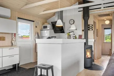 a kitchen with a stove in the middle of a room at 600-Lemvig-Porsevej-115 in Lemvig