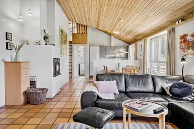a living room with a leather couch and a table at 203-Harboore-Viktoriavej-3 in Harboør