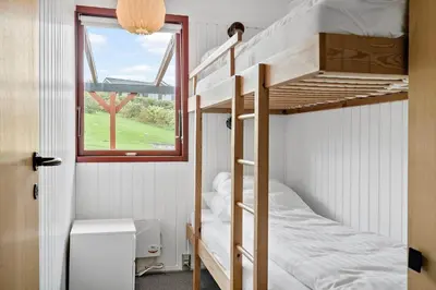 two bunk beds in a small room with a window at G431-Lemvig-Gyvelvej-31 in Lemvig