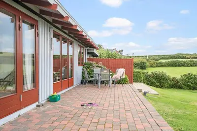 a patio with a table and chairs on a house at G431-Lemvig-Gyvelvej-31 in Lemvig
