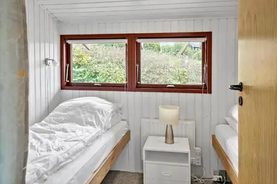 a small bedroom with a bed and a window at G431-Lemvig-Gyvelvej-31 in Lemvig