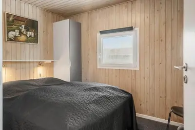 a bedroom with a bed and a window at 123-Harboore-Vejlby-Klit-83 in Harboør