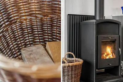 a fireplace and a basket with a fire in it at 123-Harboore-Vejlby-Klit-83 in Harboør