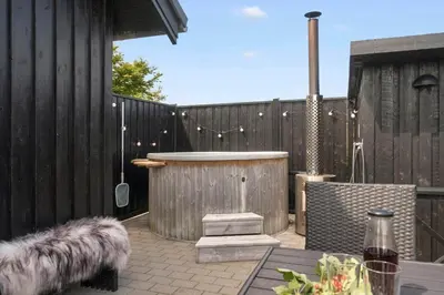 a backyard with a hot tub and a wooden fence at G245-Lemvig-Porsevej-45 in Lemvig
