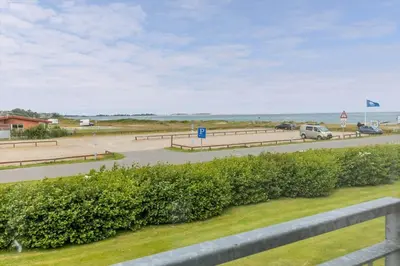 a view of a road with cars and the ocean at G522-Lemvig-Vinkelhagevej-22 in Lemvig