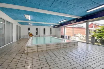 a large swimming pool with a blue ceiling at G522-Lemvig-Vinkelhagevej-22 in Lemvig