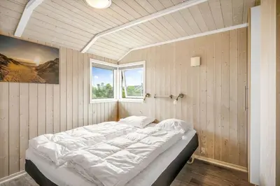 a large bed in a room with a window at 234-Harboore-Neerlandiavej-21 in Harboør