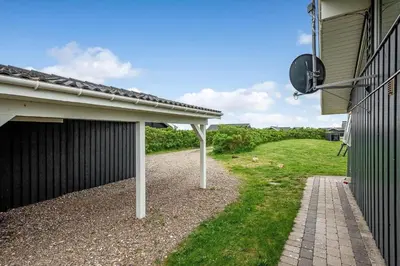 a side view of a house with a satellite at 234-Harboore-Neerlandiavej-21 in Harboør