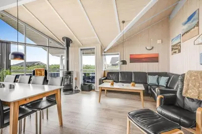 a living room with a couch and a table at 234-Harboore-Neerlandiavej-21 in Harboør