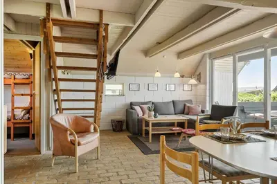 a living room with a couch and a table at 300-Harboore-Fourmivej-29 in Harboør