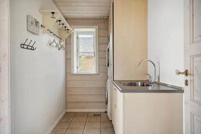 a small kitchen with a sink and a window at 289-Harboore-Strandvejen-179 in Harboør