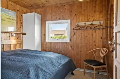 a bedroom with a bed and a window at 111-Harboore-Vejlby-Klit-125 in Harboør