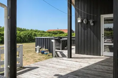 a porch of a house with a wooden deck at 111-Harboore-Vejlby-Klit-125 in Harboør