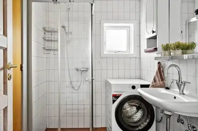 a bathroom with a washing machine and a sink at 111-Harboore-Vejlby-Klit-125 in Harboør