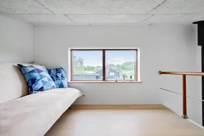 a bedroom with a bed and a window at G161-Lemvig-Porsevej-61 in Lemvig