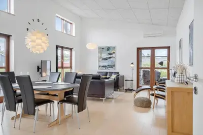 a dining room with a table and chairs and a couch at G161-Lemvig-Porsevej-61 in Lemvig