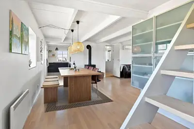 a kitchen and dining room with a table and chairs at 180-Harboore-Doblervej-89 in Harboør