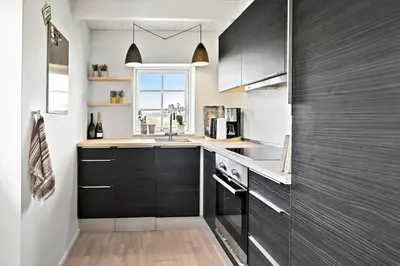 a kitchen with black cabinets and a window at 180-Harboore-Doblervej-89 in Harboør