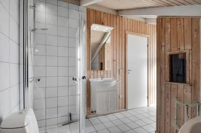 a bathroom with a shower and a sink and a toilet at 205-Harboore-Doblervej-39 in Harboør