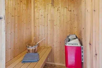 a sauna with a red cooler and a bucket at 202-Harboore-Viktoriavej-12-a in Harboør