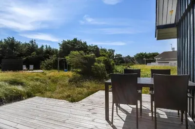 a table and chairs sitting on a patio at 301-Harboore-Themisvej-11 in Harboør