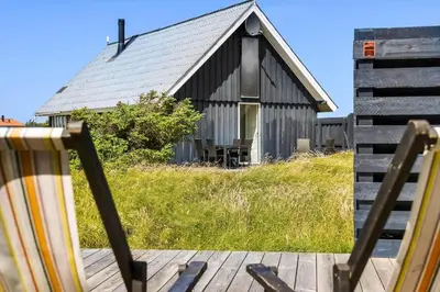 an old black barn with a porch and a deck at 301-Harboore-Themisvej-11 in Harboør