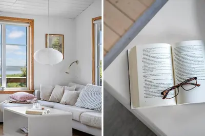 a living room with a book on the wall and a couch at G398-Lemvig-Violvej-98 in Lemvig