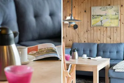 a living room with a blue couch and a table at 294-Harboore-Neerlandiavej-102 in Harboør