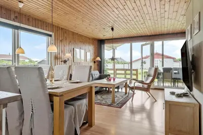 a dining room with a table and chairs at 294-Harboore-Neerlandiavej-102 in Harboør