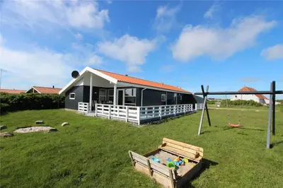 a house with a pool in front of a yard at 156-Harboore-Neerlandiavej-160 in Harboør