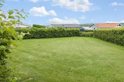 a large grassy yard with bushes and houses at G287-Lemvig-Bellisvej-87 in Lemvig