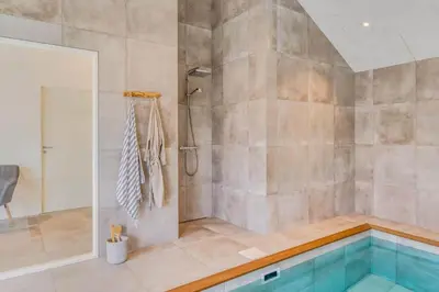 a bathroom with a swimming pool and a shower at 350-Harboore-Alkajavej-13-A in Harboør