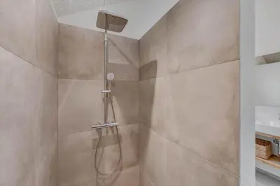 a shower with a shower head in a bathroom at 350-Harboore-Alkajavej-13-A in Harboør