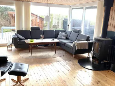 a living room with a couch and a table at 251-Harboore-Neerlandiavej-230 in Harboør