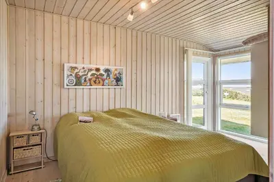 a bedroom with a large bed and a window at G249-Lemvig-Bellisvej-49 in Lemvig