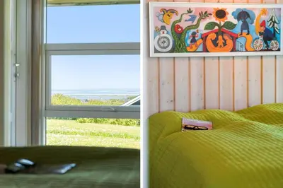 two pictures of a bedroom with a bed and a window at G249-Lemvig-Bellisvej-49 in Lemvig