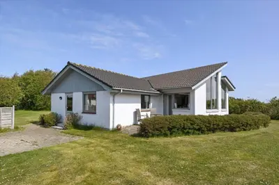 a white house with a gray roof at G129-Lemvig-Gjelleroddevej-129 in Lemvig