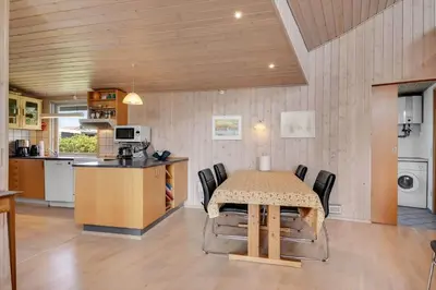 a kitchen and dining room with a table and chairs at G129-Lemvig-Gjelleroddevej-129 in Lemvig
